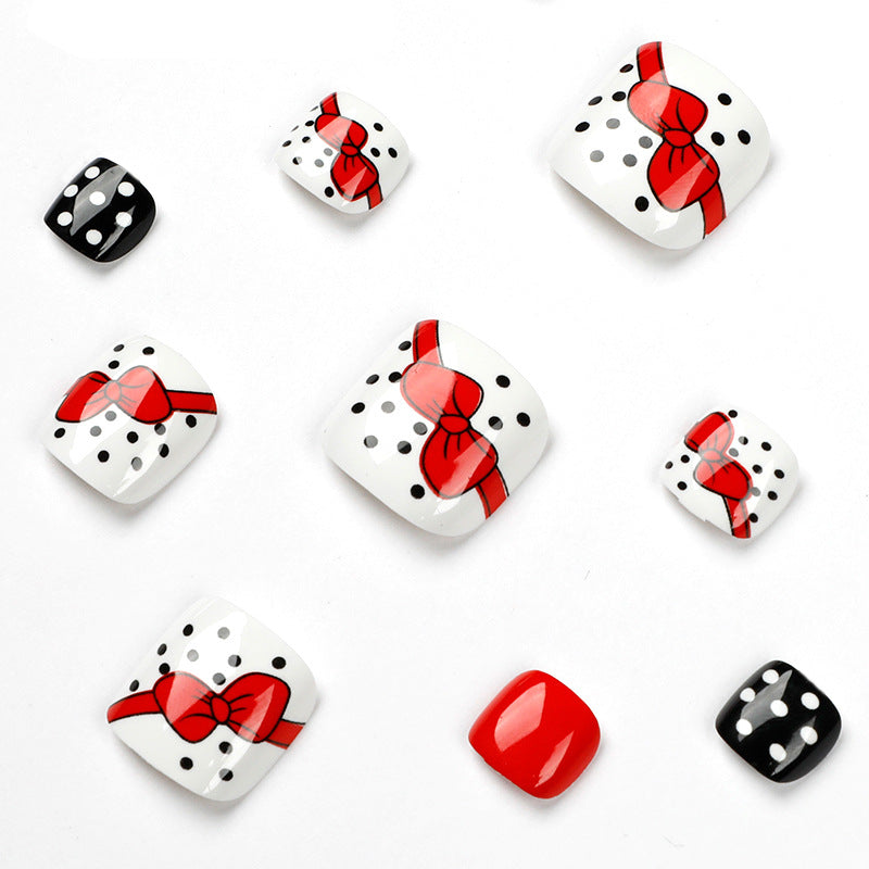 Artful toenail design with elegant bow motifs Stornfield