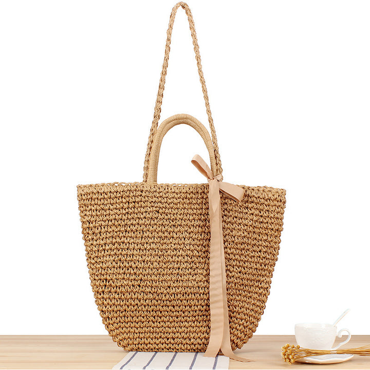 Beach bag made of natural raffia with playful design and elegant bow decoration Stornfield