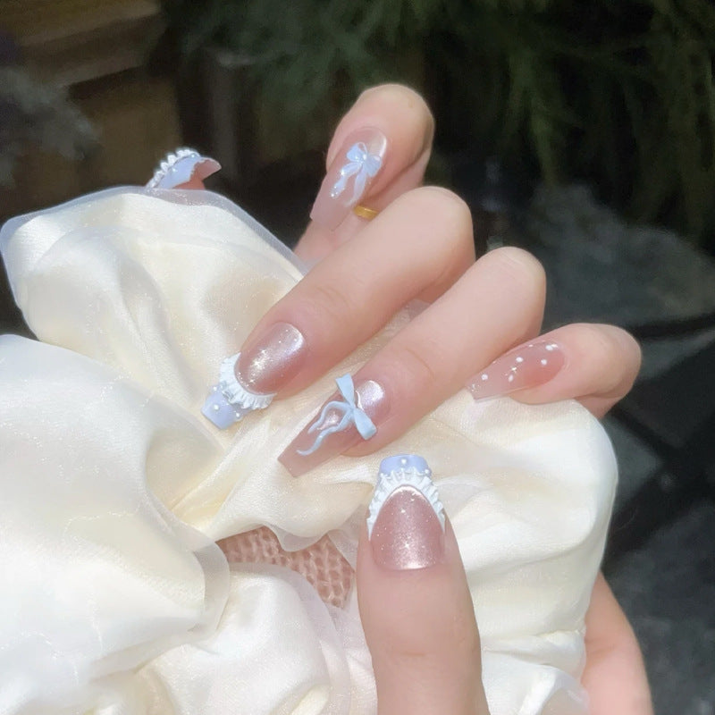 Art nail set with filigree bows and glitter accents Stornfield