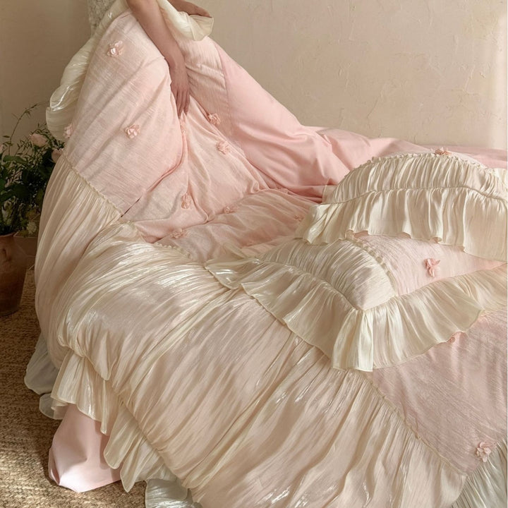 Satin look quilted bedspread with pleated ruffle and 3D flower appliqué