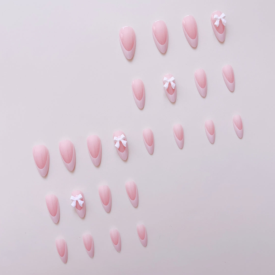 Artificial nail set with elegant tips and delicate bow decorations Stornfield