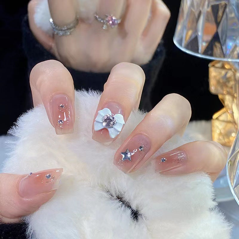 Artistic nail tips with floral and glittering accents Stornfield