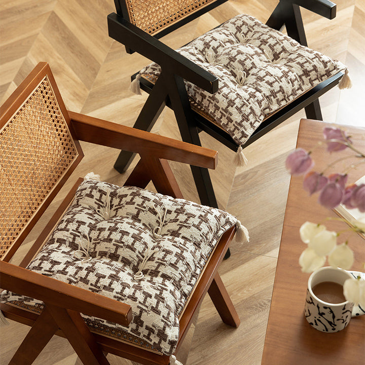 Tufted decorative cushion with woven houndstooth relief and tassels