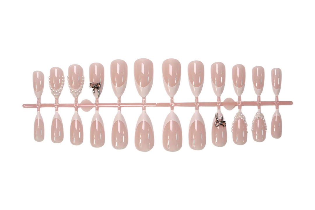 Glamorous artificial nail set with elegant bows and glitter accents Stornfield