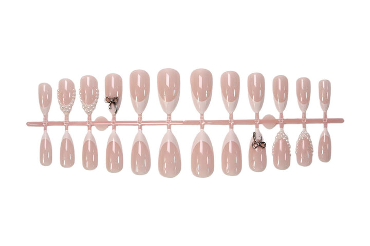 Glamorous artificial nail set with elegant bows and glitter accents Stornfield