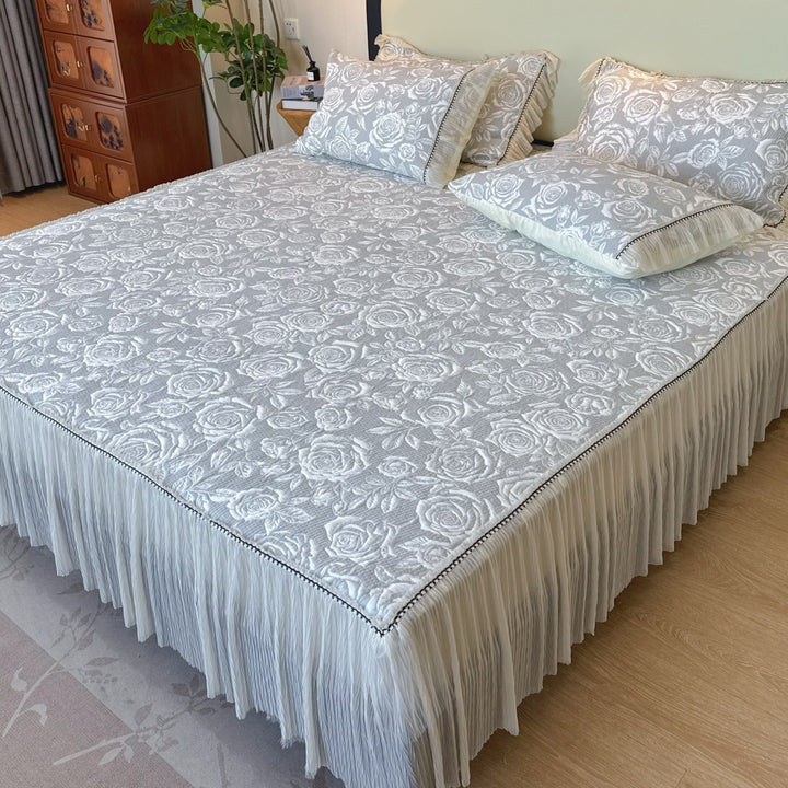 Quilted mattress and pillow set with butterfly motif and pleated bed ruffle