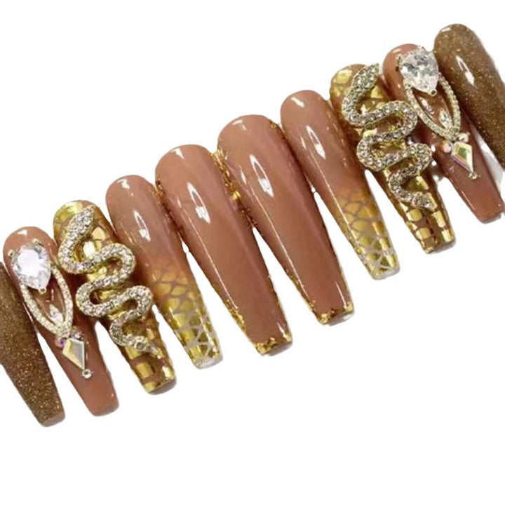 Exclusive stiletto artificial nails with glitter and jewelry accents Stornfield