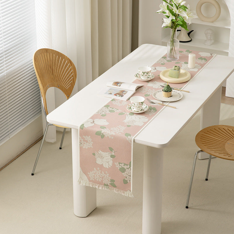 Woven table runner with floral jacquard pattern and fringed edge Stornfield