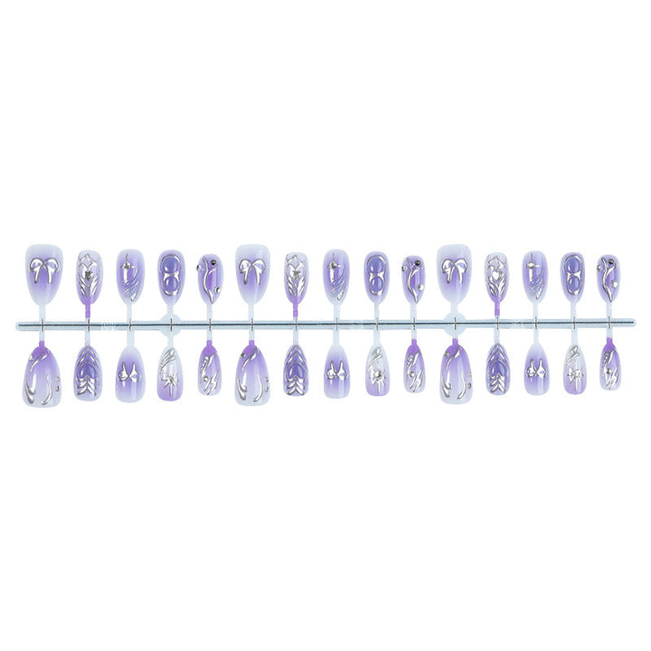Acrylic nail set with elegant ombre design and delicate embellishments Stornfield