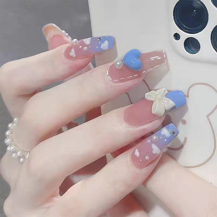 Artificial nails with elegant bow accents and pearl decorations Stornfield