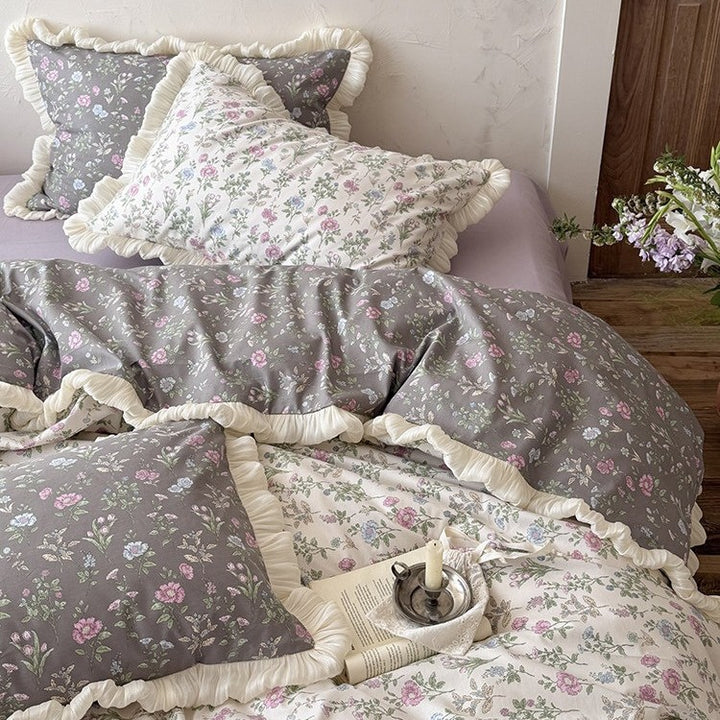 Reversible quilt in vintage botanical design with ruffle and matching pillowcases