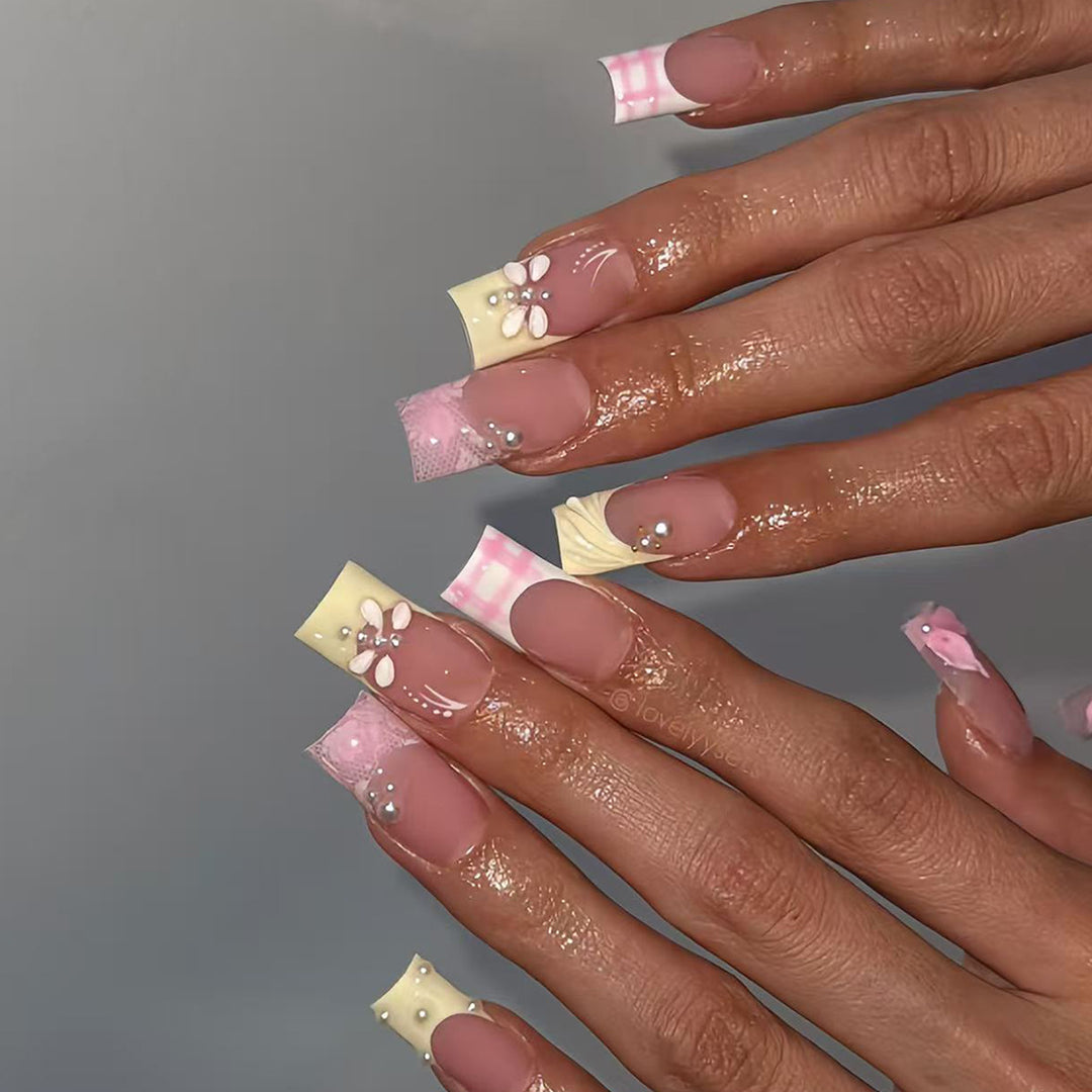 Artificial nails with creative floral designs and glitter accents Stornfield