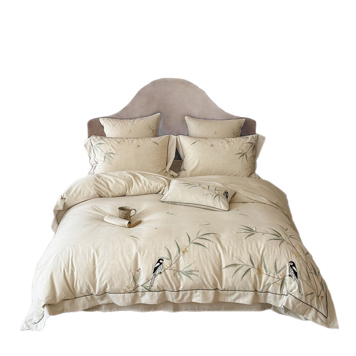 Embroidered cotton-linen bedding set with ruffled trim and bow accents