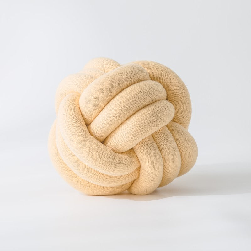 Decorative knitted knot cushion as a decorative pillow made of soft jersey