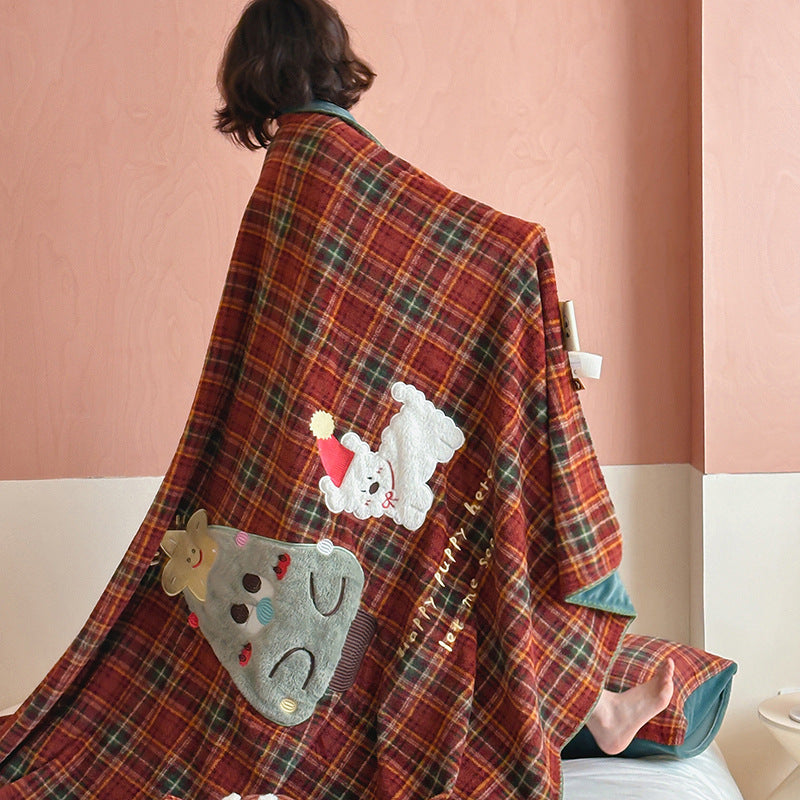 Plaid blanket checkered with appliqued animal motifs and soft velour lining