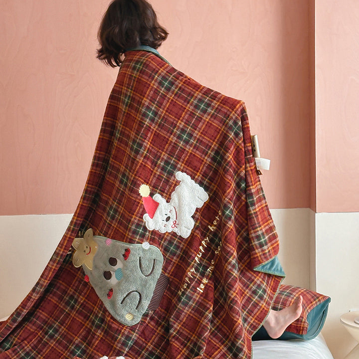 Plaid blanket checkered with appliqued animal motifs and soft velour lining