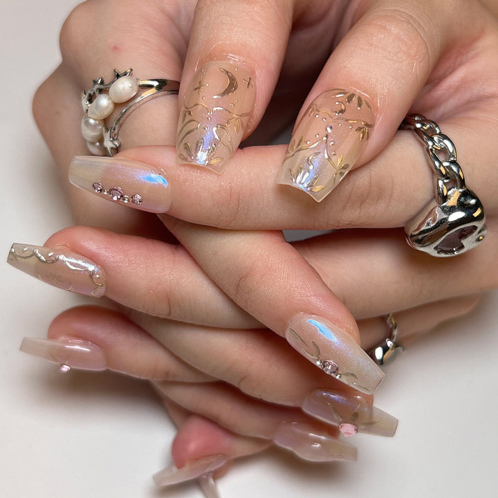 Artificial nail art with elegant rhinestone and glitter effects Stornfield