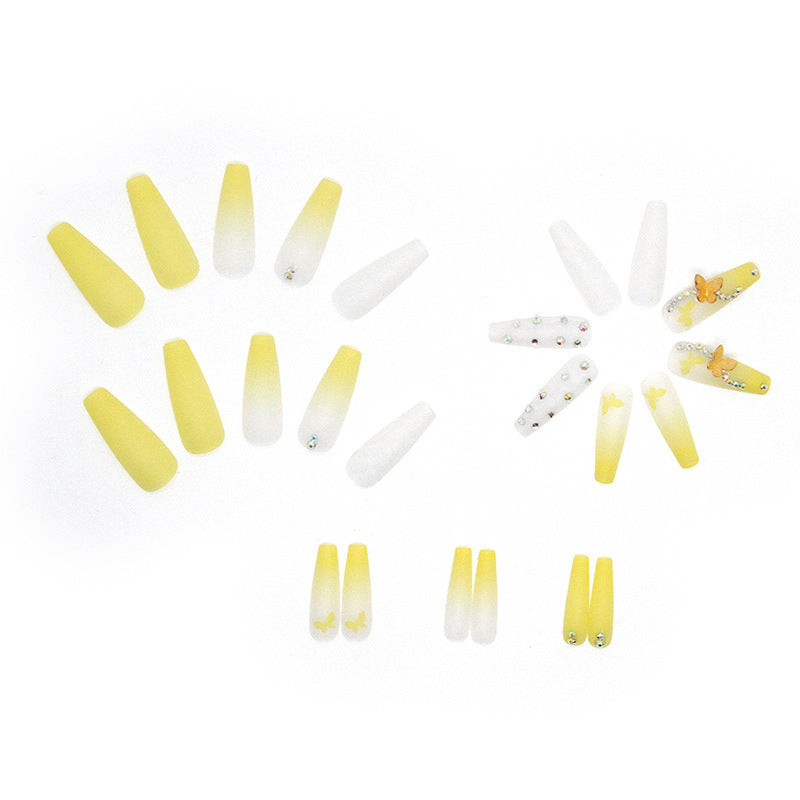 Artificial nail extensions with floral accents and rhinestones Stornfield