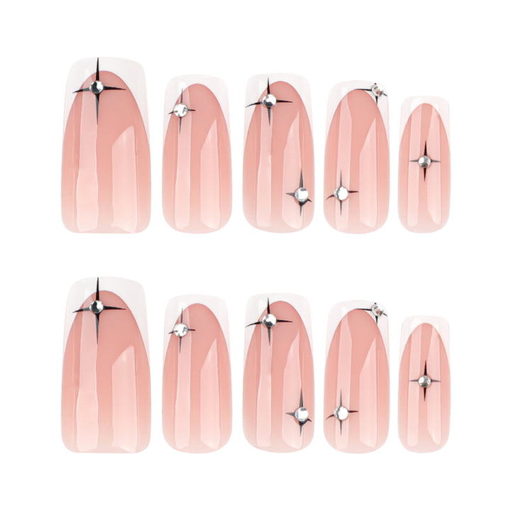 Artificial nail extensions with elegant French tip and glitter accents Stornfield