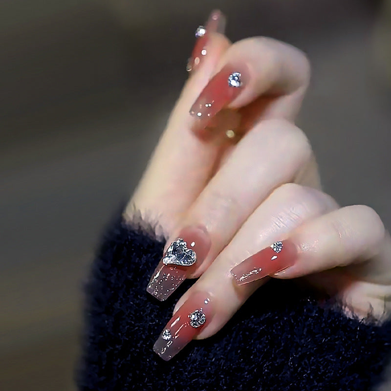 Acrylic nail set with elegant heart and rhinestone decorations Stornfield