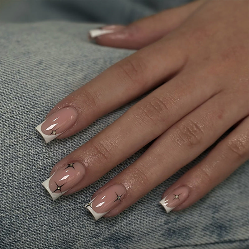 Artificial nail extensions with elegant French tip and glitter accents Stornfield