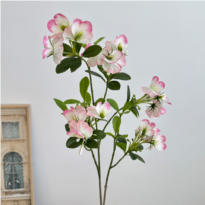 Artificial flower branch with vibrant pink flowers