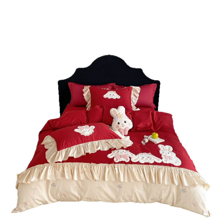 Playful bedding set with ruffles, three-dimensional appliqués, and delicate embroidery