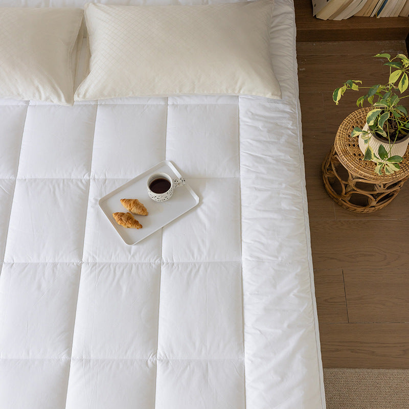 Padded mattress topper with a light down look and breathable hollow fiber filling