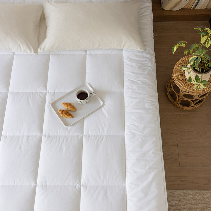 Padded mattress topper with a light down look and breathable hollow fiber filling