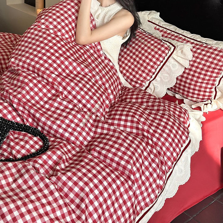 Quilted bedding set made of cotton blend with check pattern and decorative lace ruffle