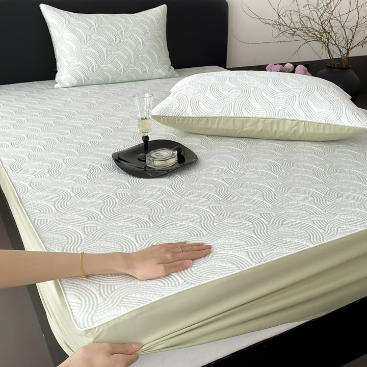 Quilted mattress protector with all-round elastic and floral relief structure