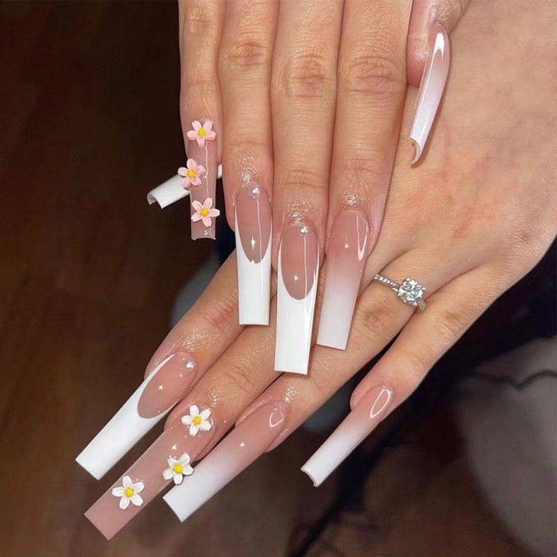 Artful nail extensions with elegant gradient and creative floral accents Stornfield