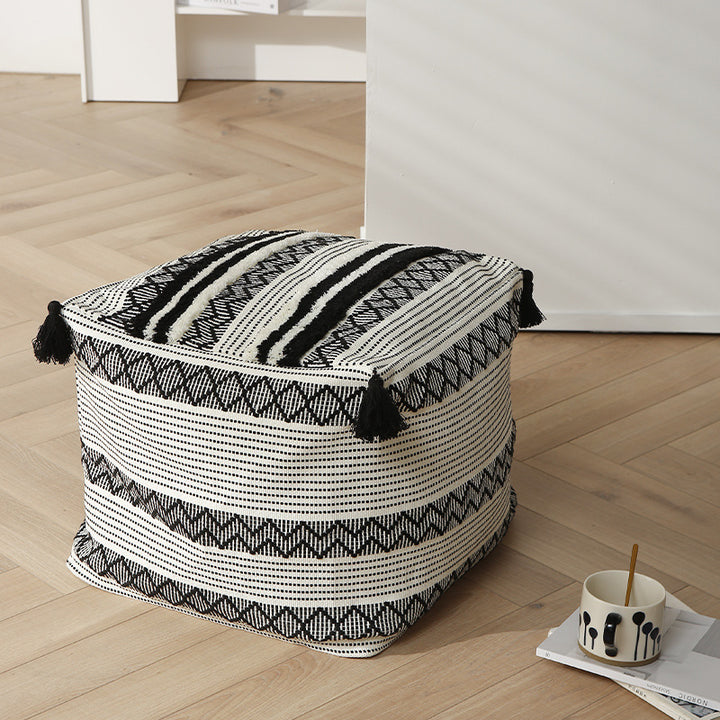 Braided square floor seat pouf with tassels and woven ethnic pattern