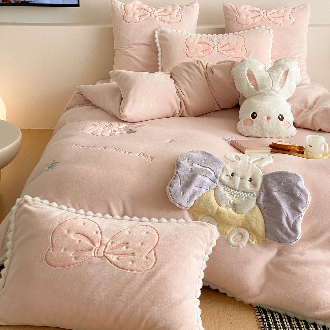 Cozy quilted bedding set with plush appliqué and pompom trim
