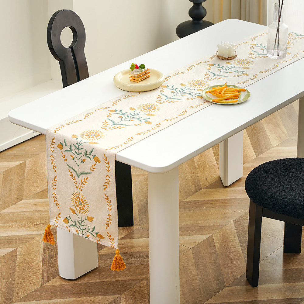 Table runner made of linen blend with floral block print motifs and tassels