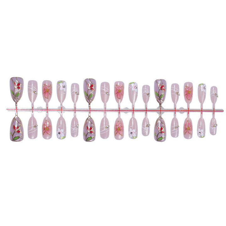 Artificial nail set with luxurious floral designs and glitter accents Stornfield