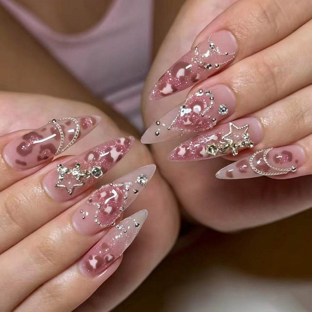 Artistic stiletto nails with glitter and jewelry accents Stornfield