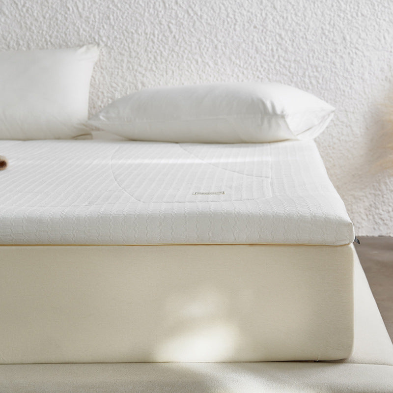 Padded mattress topper with quilted microfiber surface and non-slip fitted edge