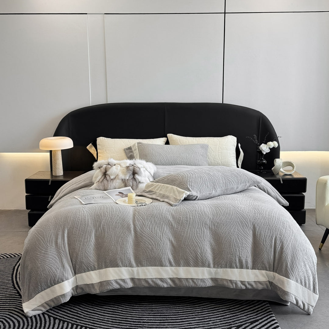 Quilted bedding set made of cotton blend with raised leaf texture and contrasting border