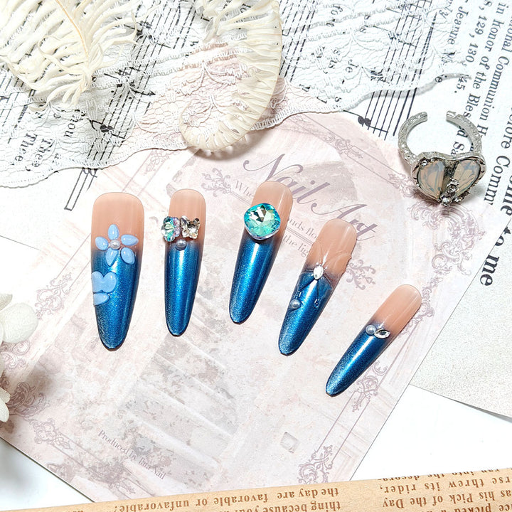 Artificial nails in elegant design with artistic decorations and glitter accents Stornfield