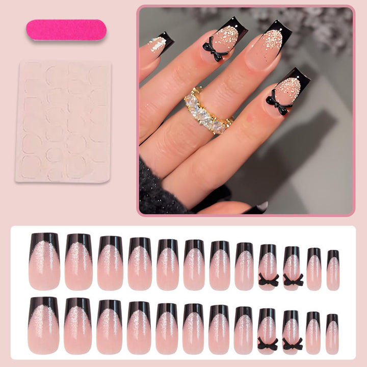 Artificial nail set with elegant glitter accents and bow details Stornfield
