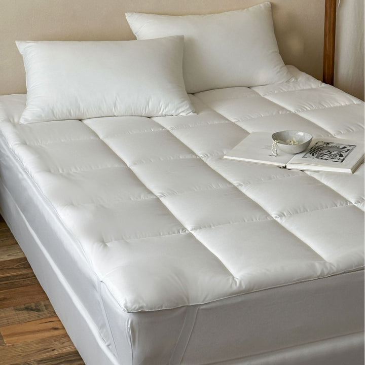 Padded comfort topper with quilted compartments and elastic corner bands