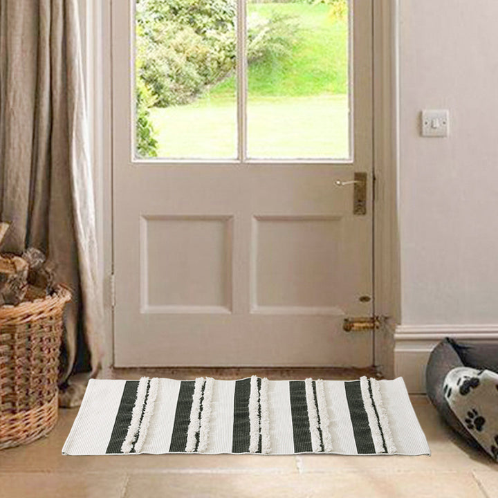 Rectangular flat-woven cotton rug with raised tufted stripes