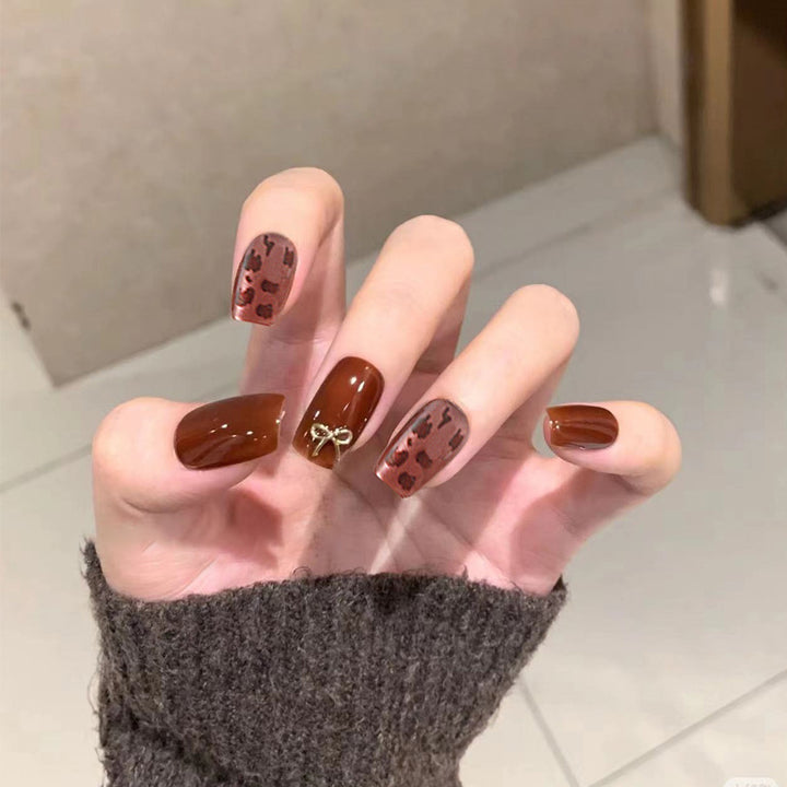 Nail set with elegant leopard pattern and luxurious accents Stornfield