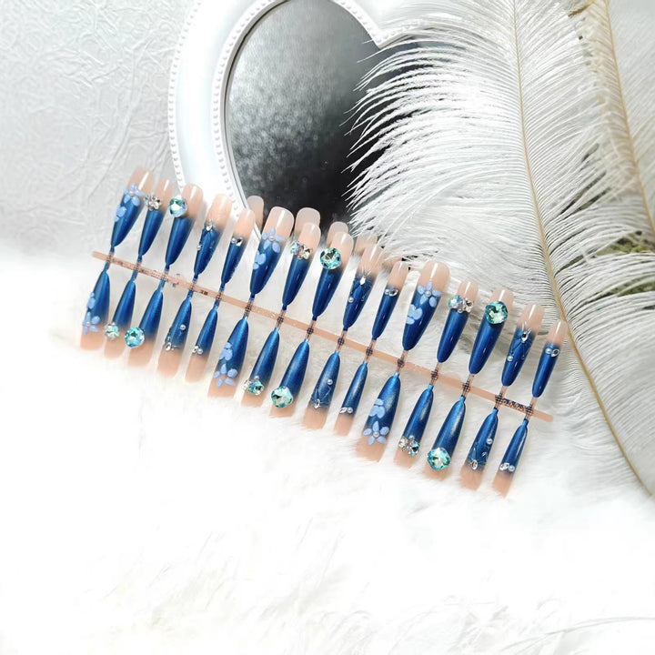 Elegant artificial nails with floral applications and glitter elements Stornfield