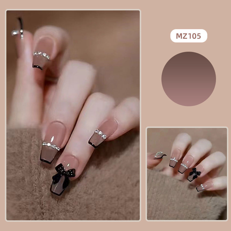 Elegant nail design with bow and rhinestone details Stornfield