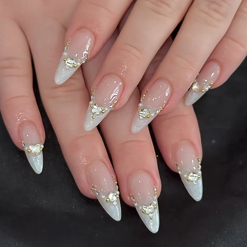 Acrylic nail set with elegant rhinestone decorations and glamorous designs Stornfield