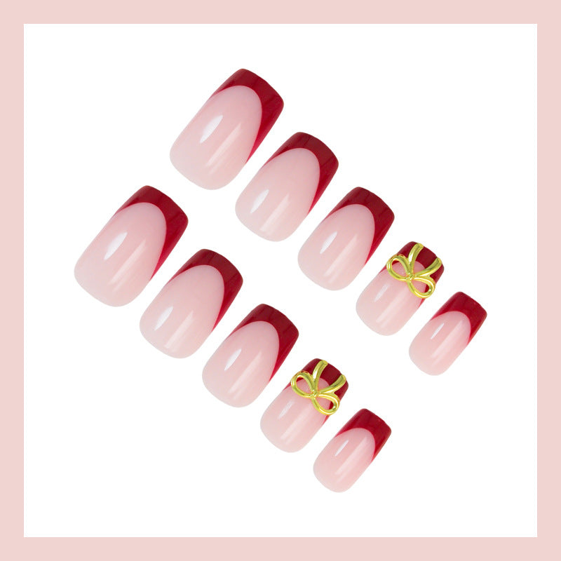 Artificial nail set with elegant red tips and refined bow decorations Stornfield