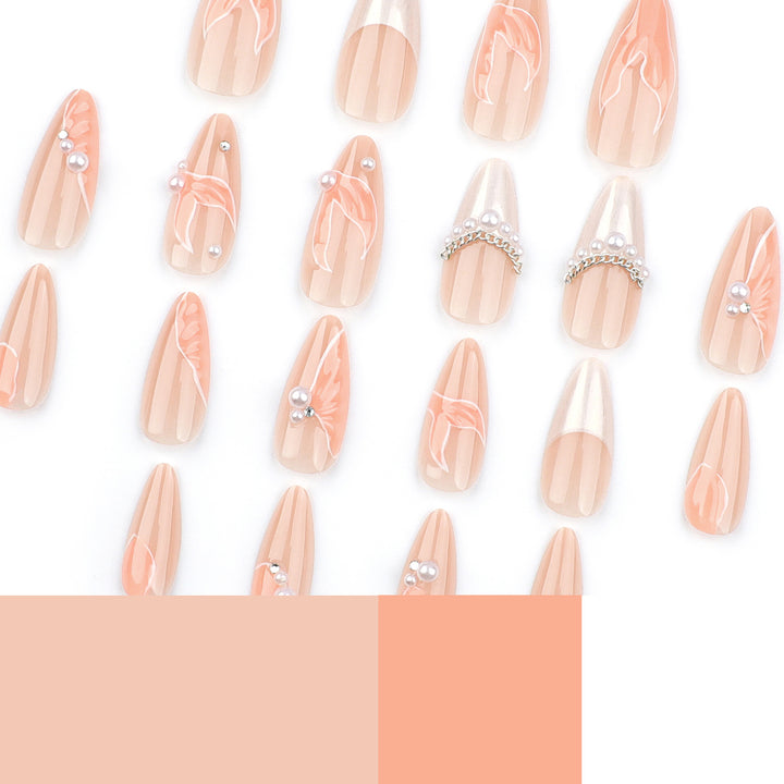 Artistic stiletto nails with pearl and flower embellishments Stornfield