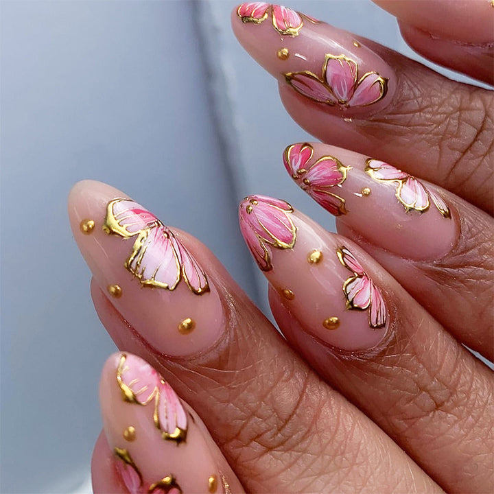 Artificial nails with graceful floral patterns and golden accents Stornfield